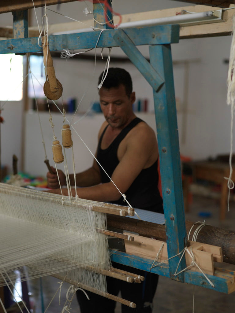 Artisan Abdelazziz in Mahdia weaving blue fouta on pedal loom