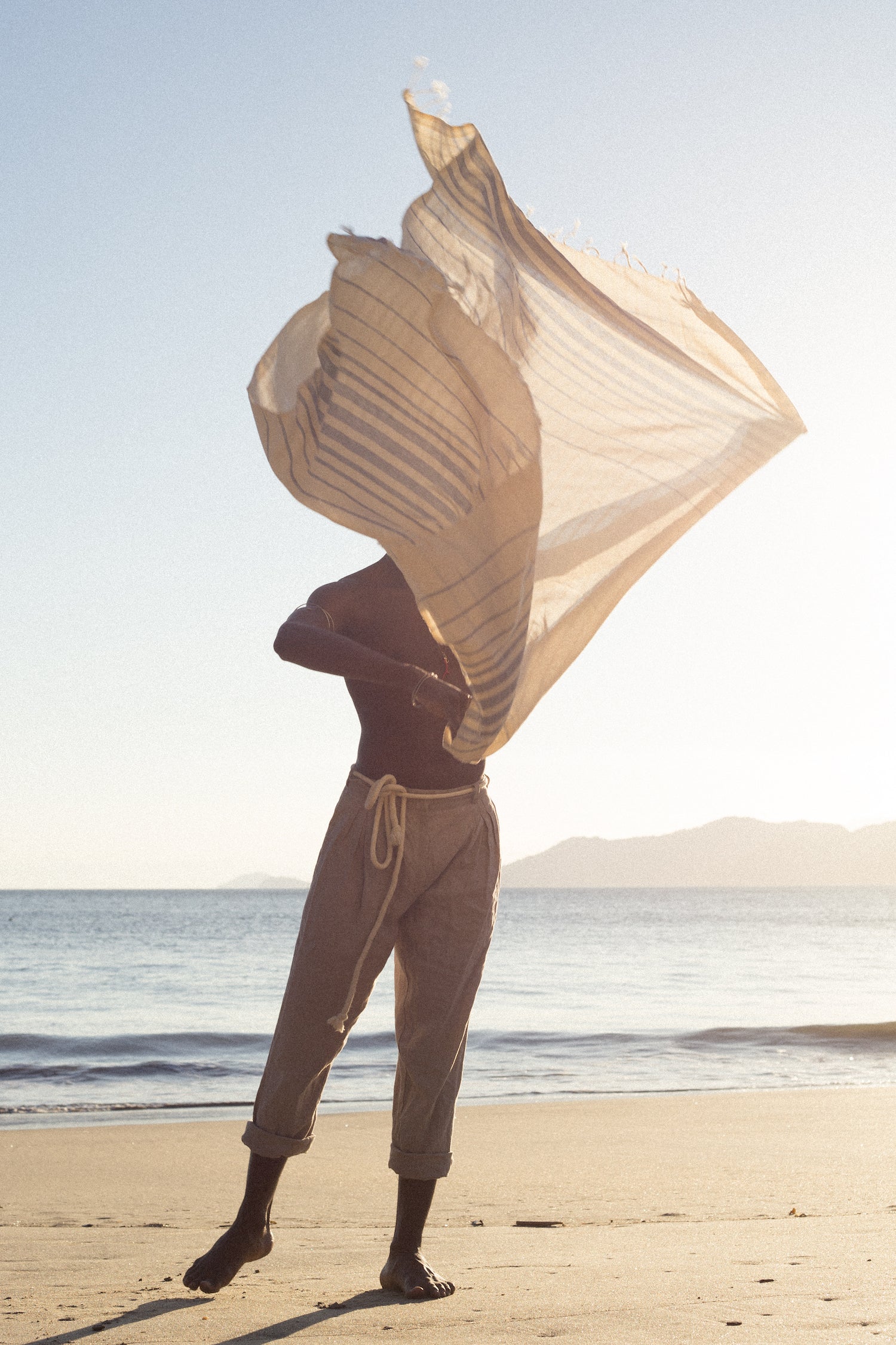 Model on the beach with flying fouta