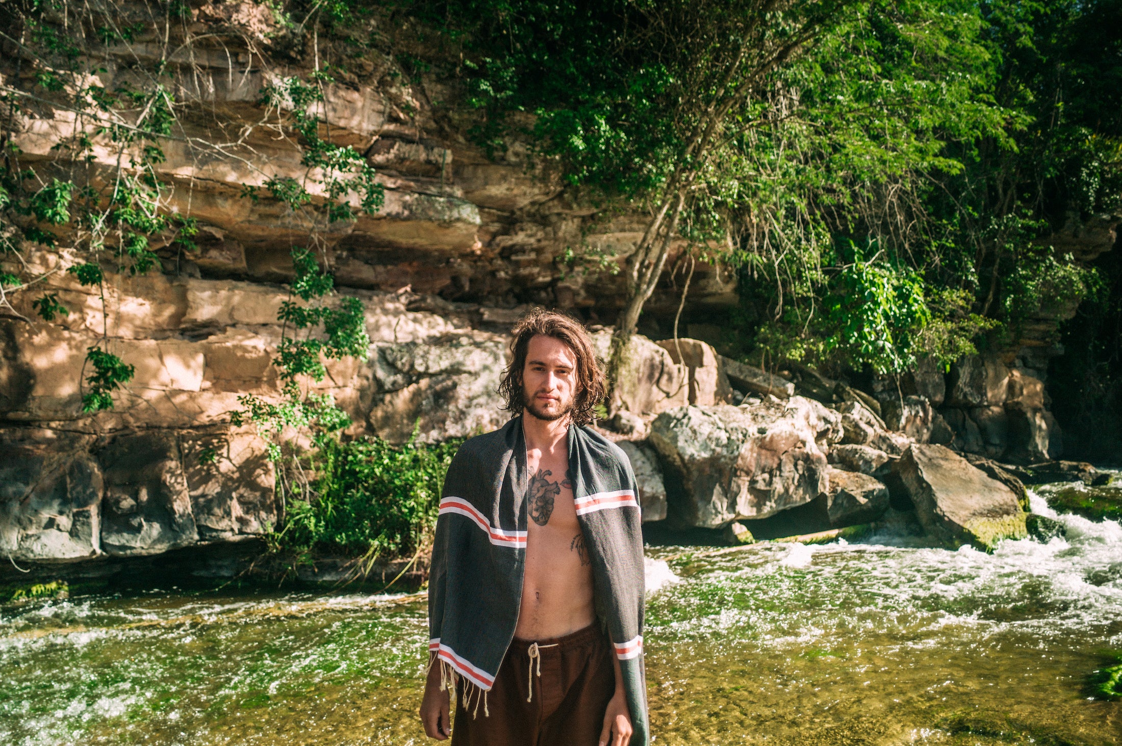Man in front of waterfall wearing a fouta